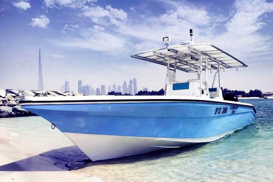 Leisure boat at marina with Burj Khalifa skyline
