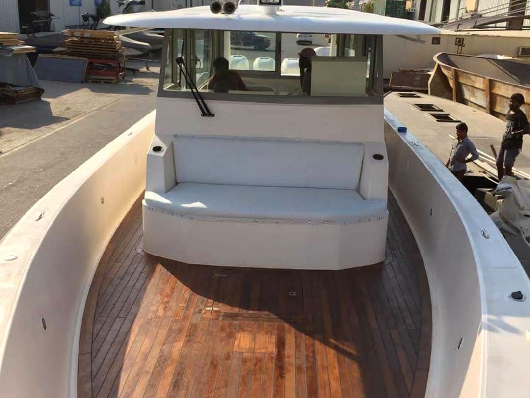 New boat cockpit with teak deck and bench seating in workshop