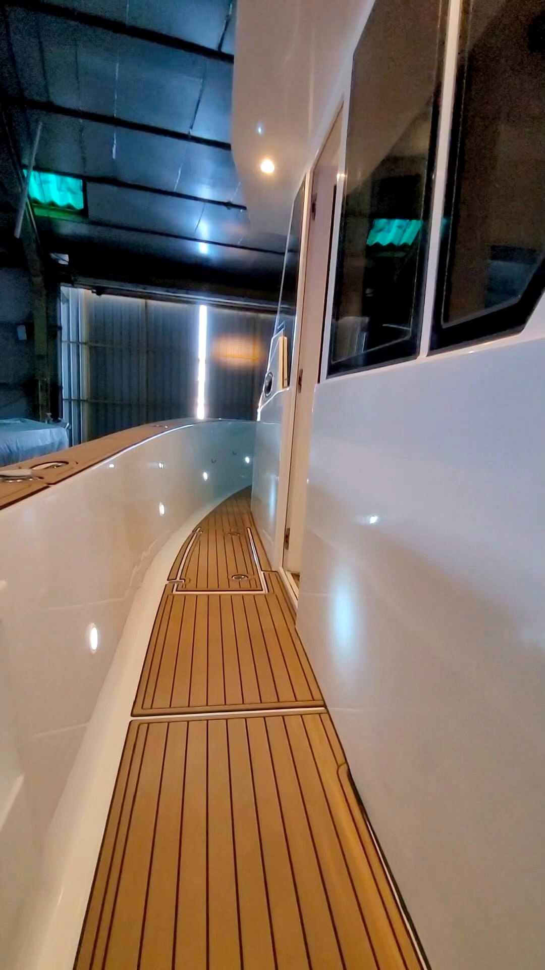 Teak deck walkway along the side of a boat in the workshop