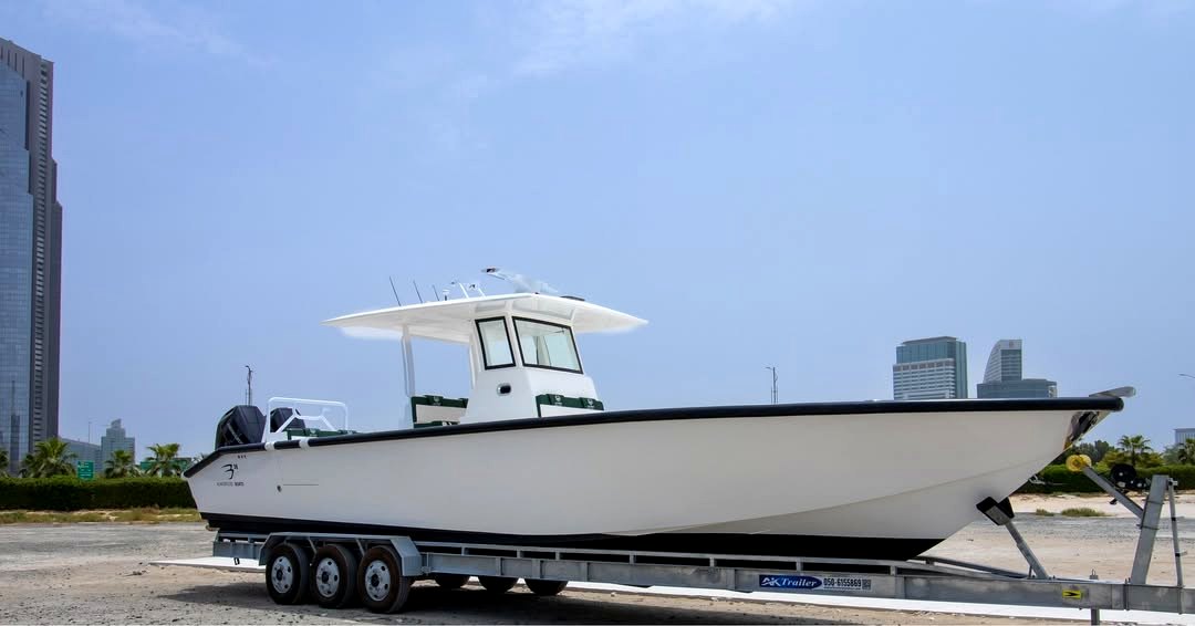 Large white center console boat on trailer with Dubai skyline