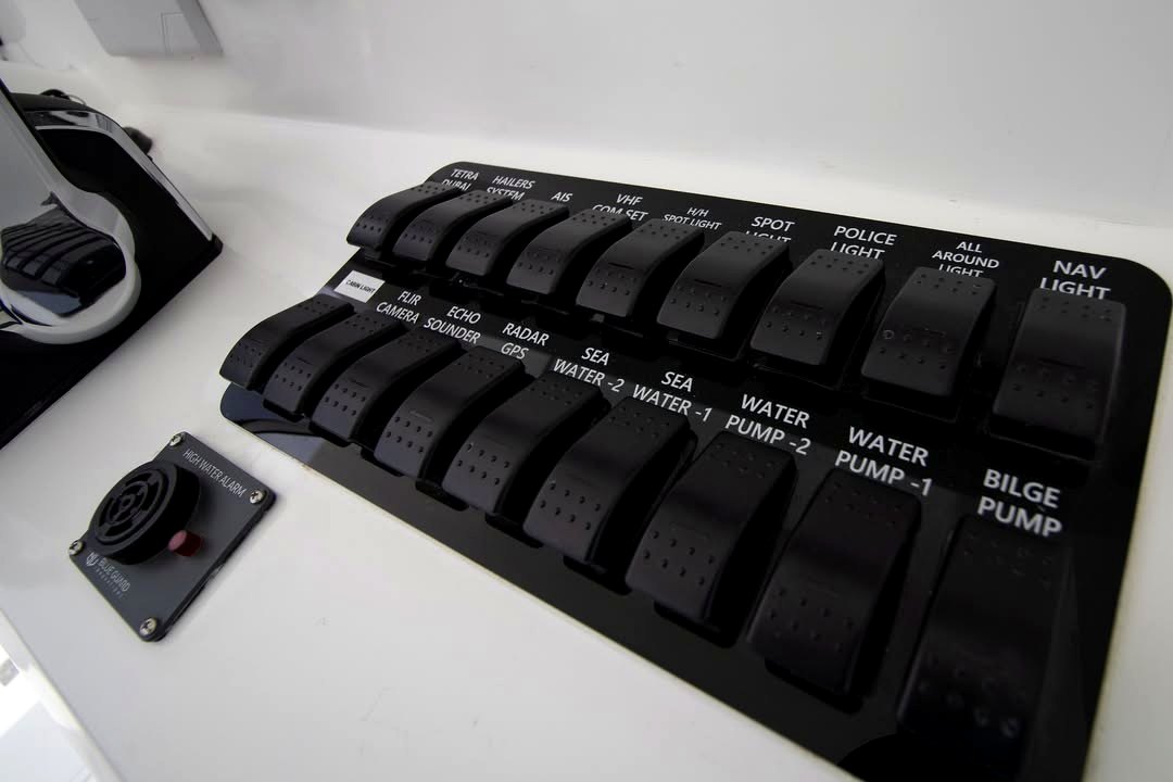Detailed switch panel showing TETRA, POLICE LIGHT, FLIR CAMERA, RADAR, AIS, VHF labels