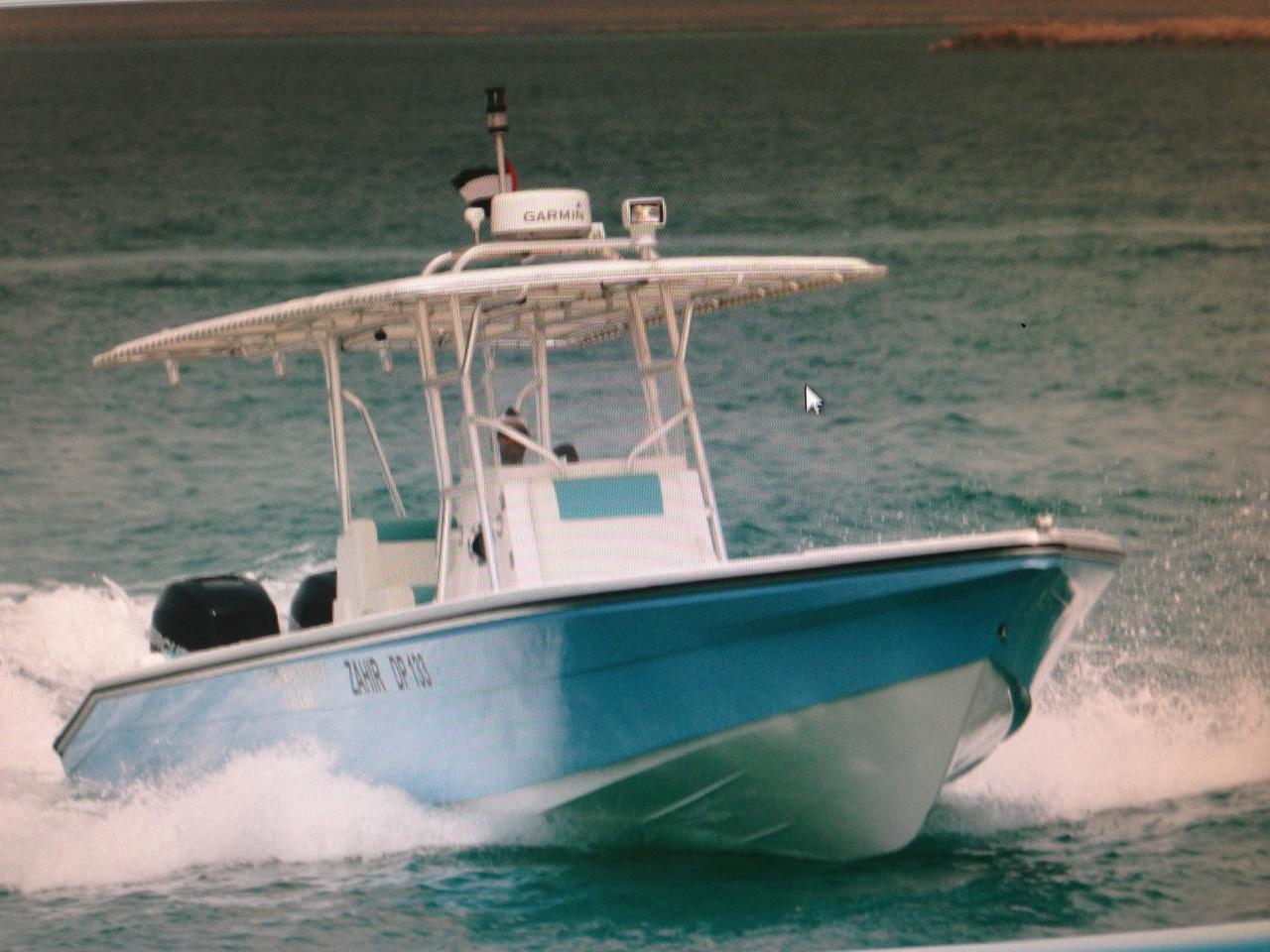 Teal center console Zahir DP-133 planing at speed on the Gulf during a sea trial